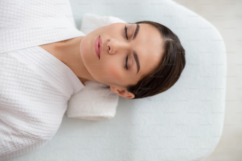Beautiful serene lady lying with her eyes closed stock photo