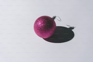 Christmas ornament with pastel grey background and deep shadows. Minimal contemporary concept.