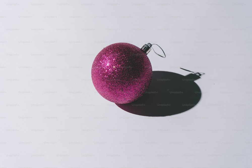 Christmas ornament with pastel grey background and deep shadows. Minimal contemporary concept.