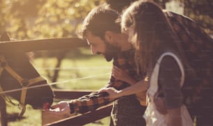 Cultivate love for animals. Father and daughter on farm.