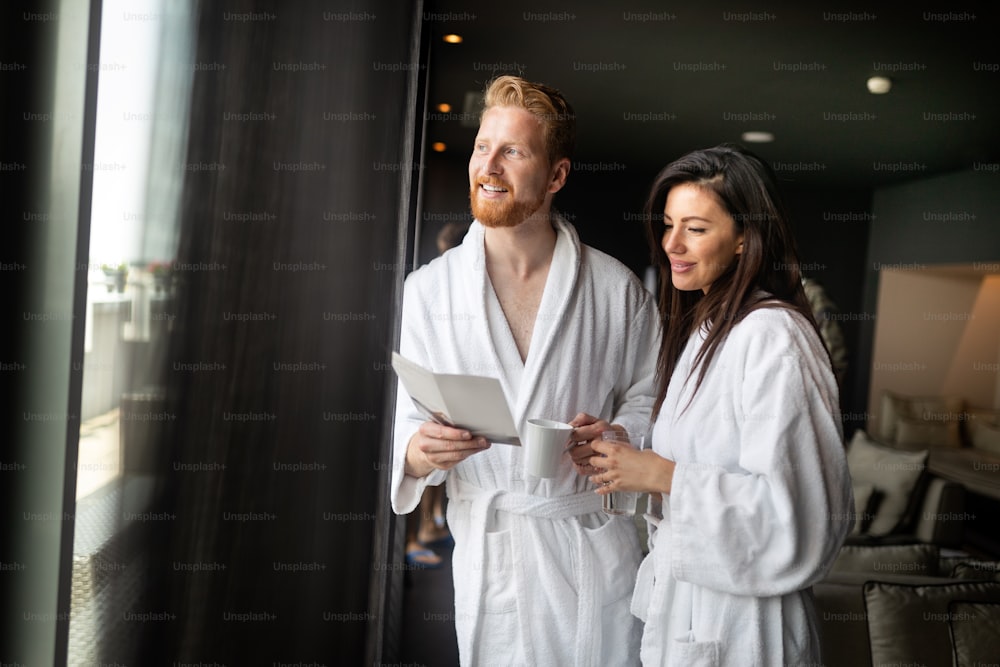 Happy young couple enjoying treatments and relaxing at wellness spa center