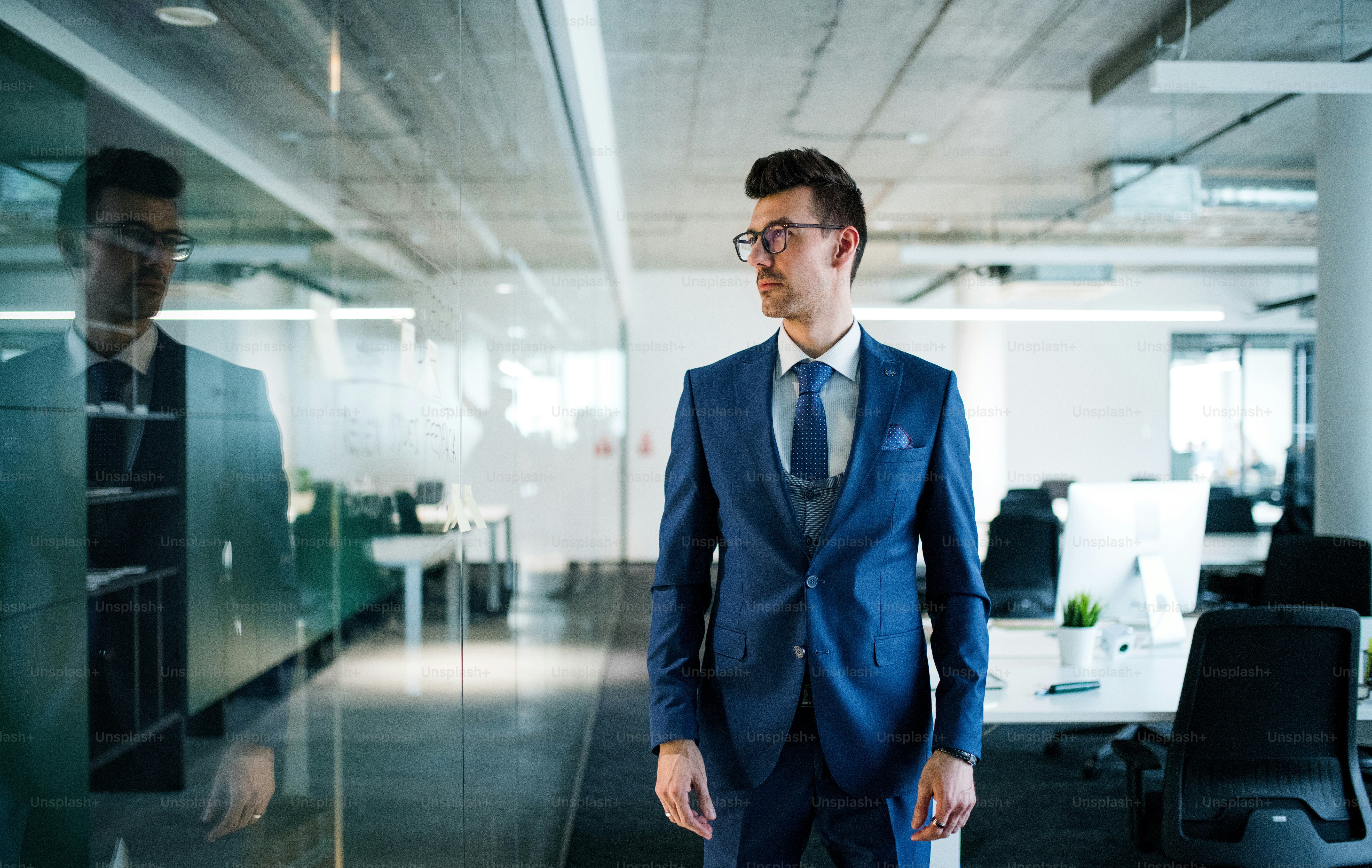 A portrait of young businessman standing in an office. Copy space.