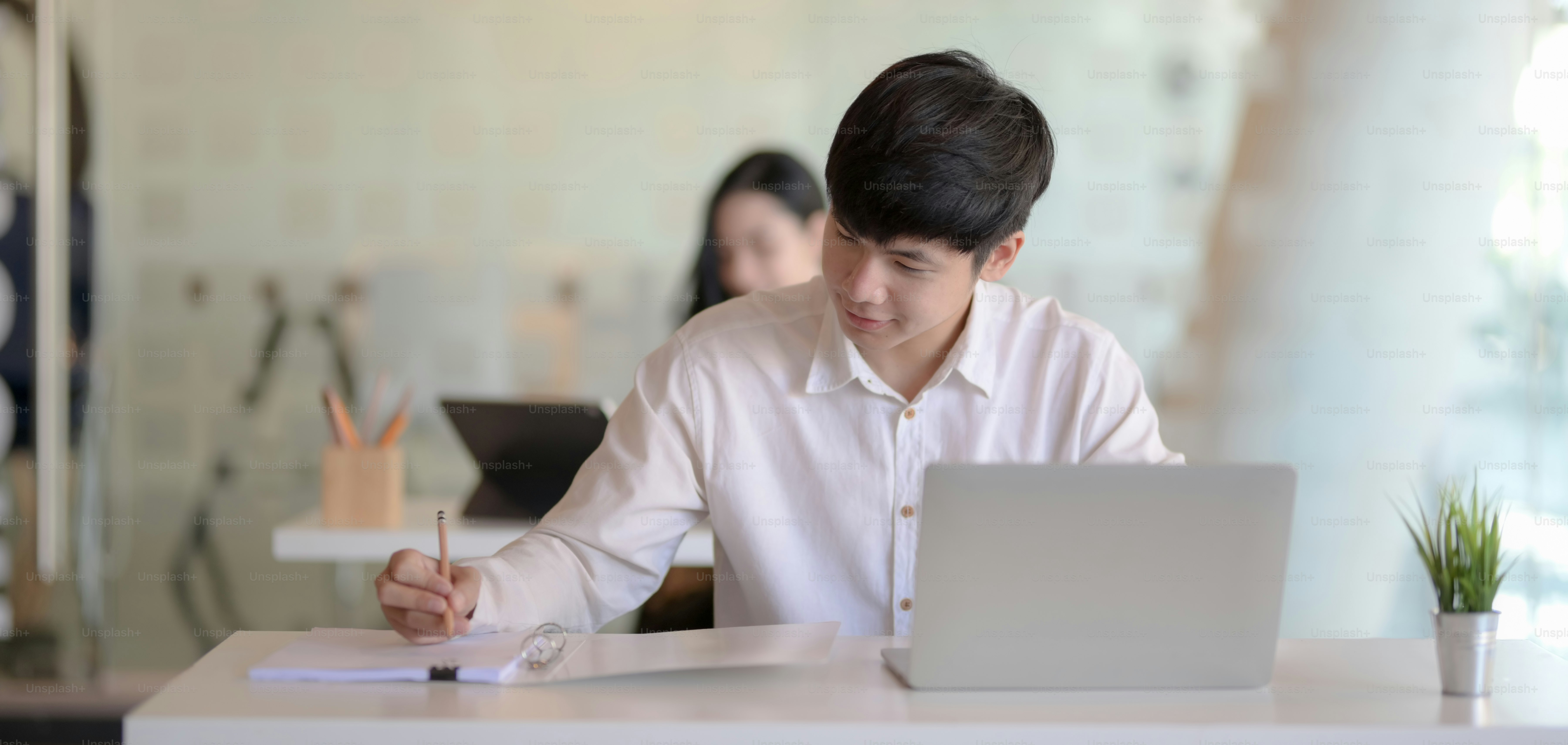 Cropped shot of young professional businessman working on his project in modern office room