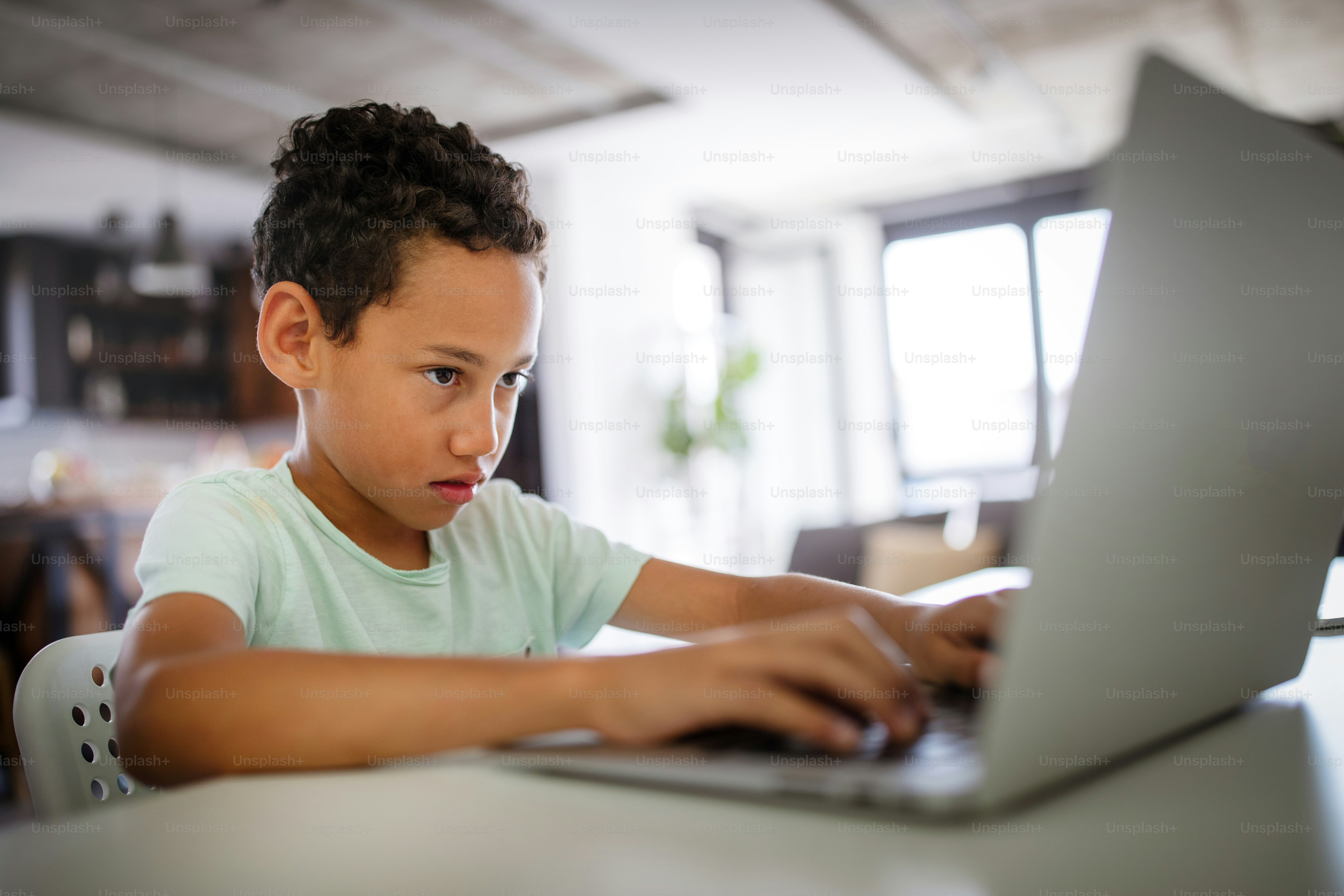 African boy spending time with notebook and modern technology