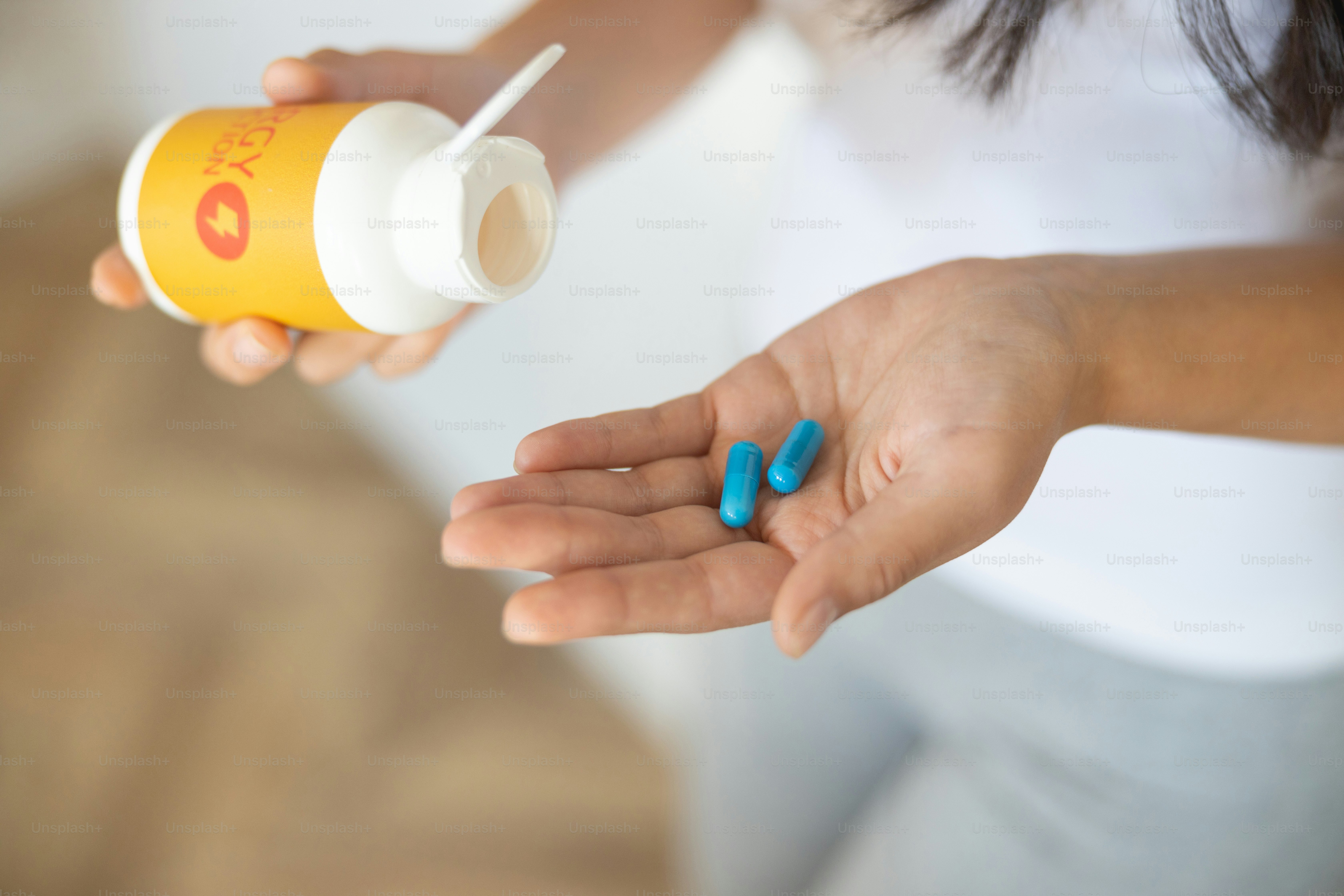 Cropped photo of a female hand taking out pills