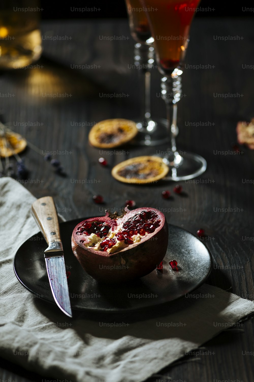 A pomegranate, for Prosecco cocktail, garnished with dryed orange slice