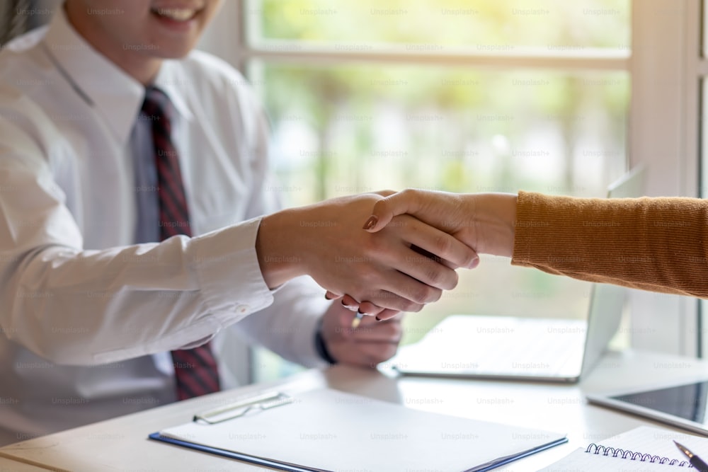 Businessman handshake with customer to confirm business deals.