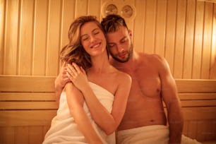 Relax your mind. Smiling couple in sauna.
