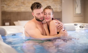Some moments should last forever. Young couple in hot tub.