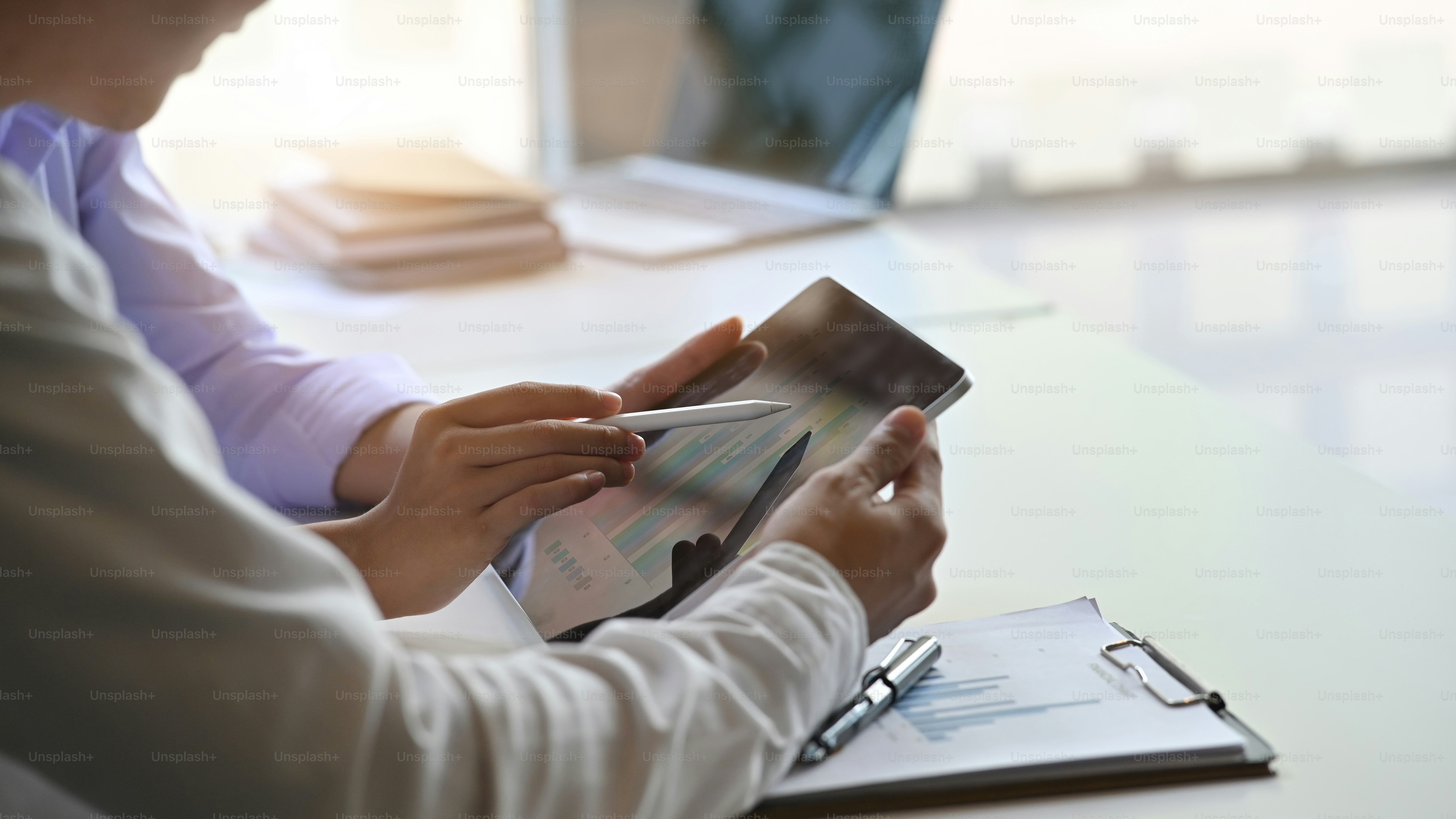 Close-up business people brainstorming with looking they finance data in table.