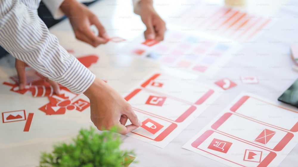 Group of professional UX graphic designer discussing the smartphone template project together in modern office room