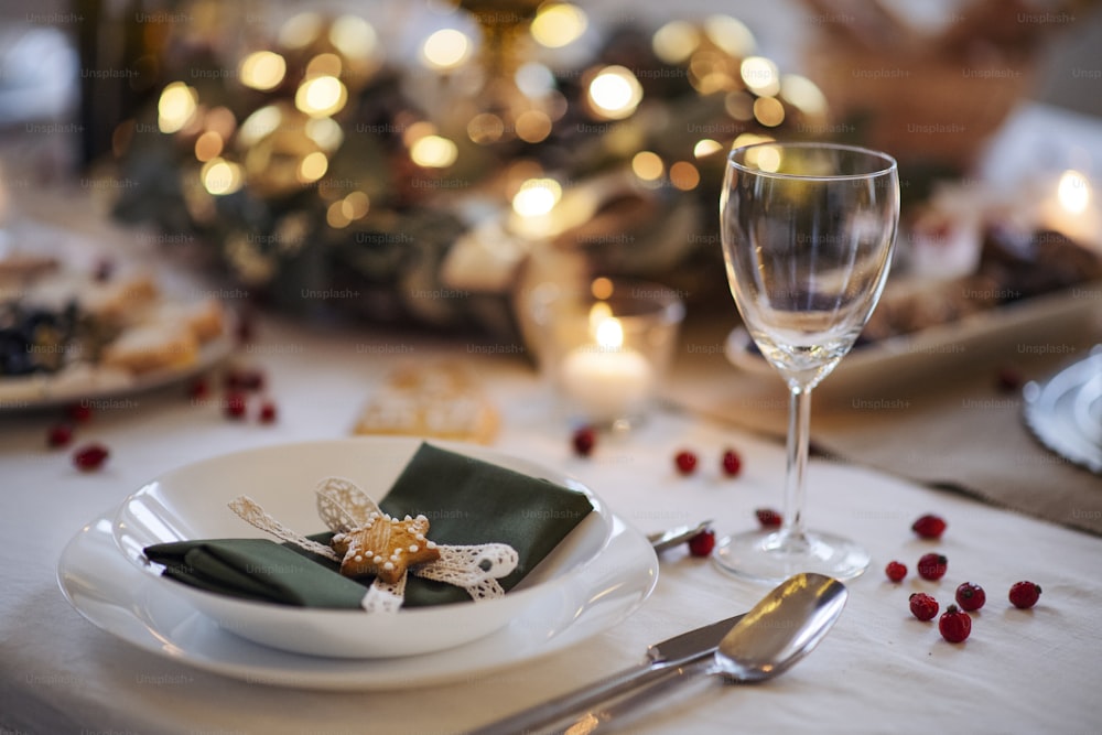 A close-up of decorated table set for dinner meal at Christmas time.