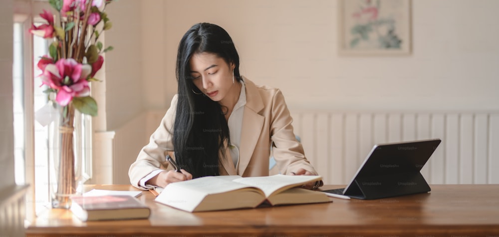 Portrait of young beautiful businesswoman working on her project in comfortable office room