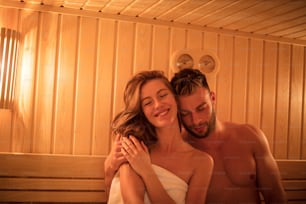 Relax your mind. Smiling couple in sauna.