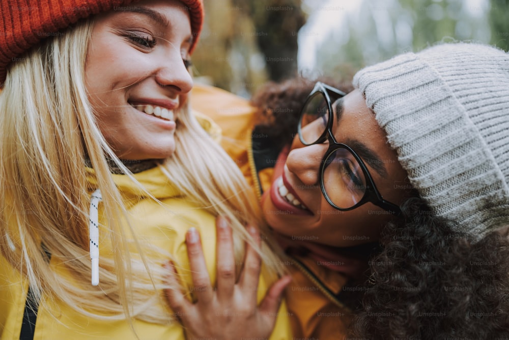 Lächelnde und glückliche Damen bleiben im Park Stockfoto