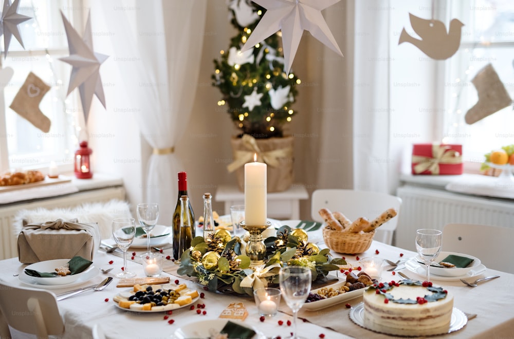 A decorated table set for dinner meal at Christmas time.