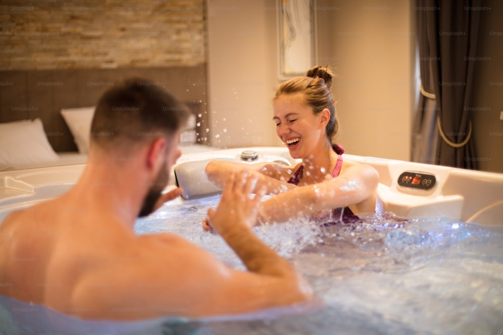 Funny time. Couple in Hot Tub. Focus on background.