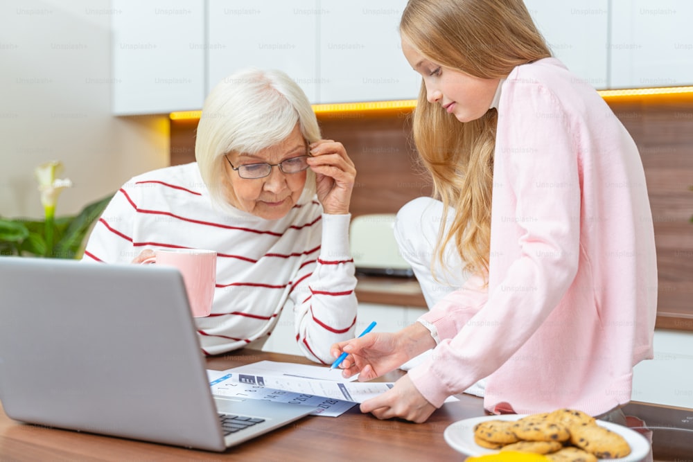 Stylish senior woman in glasses scrutinizing an application form