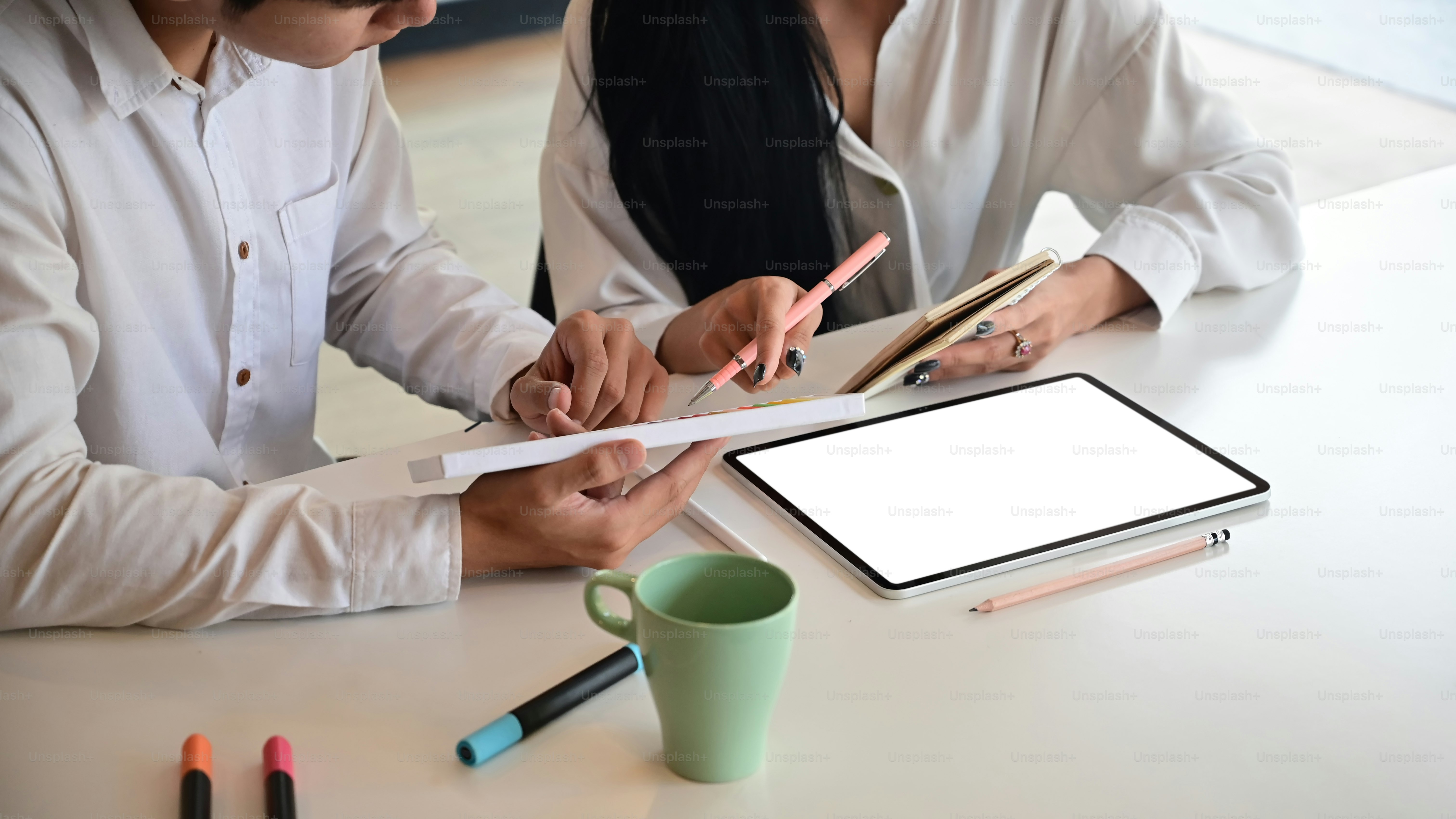 Cropped shot creative they meeting with tablet computer on desk.