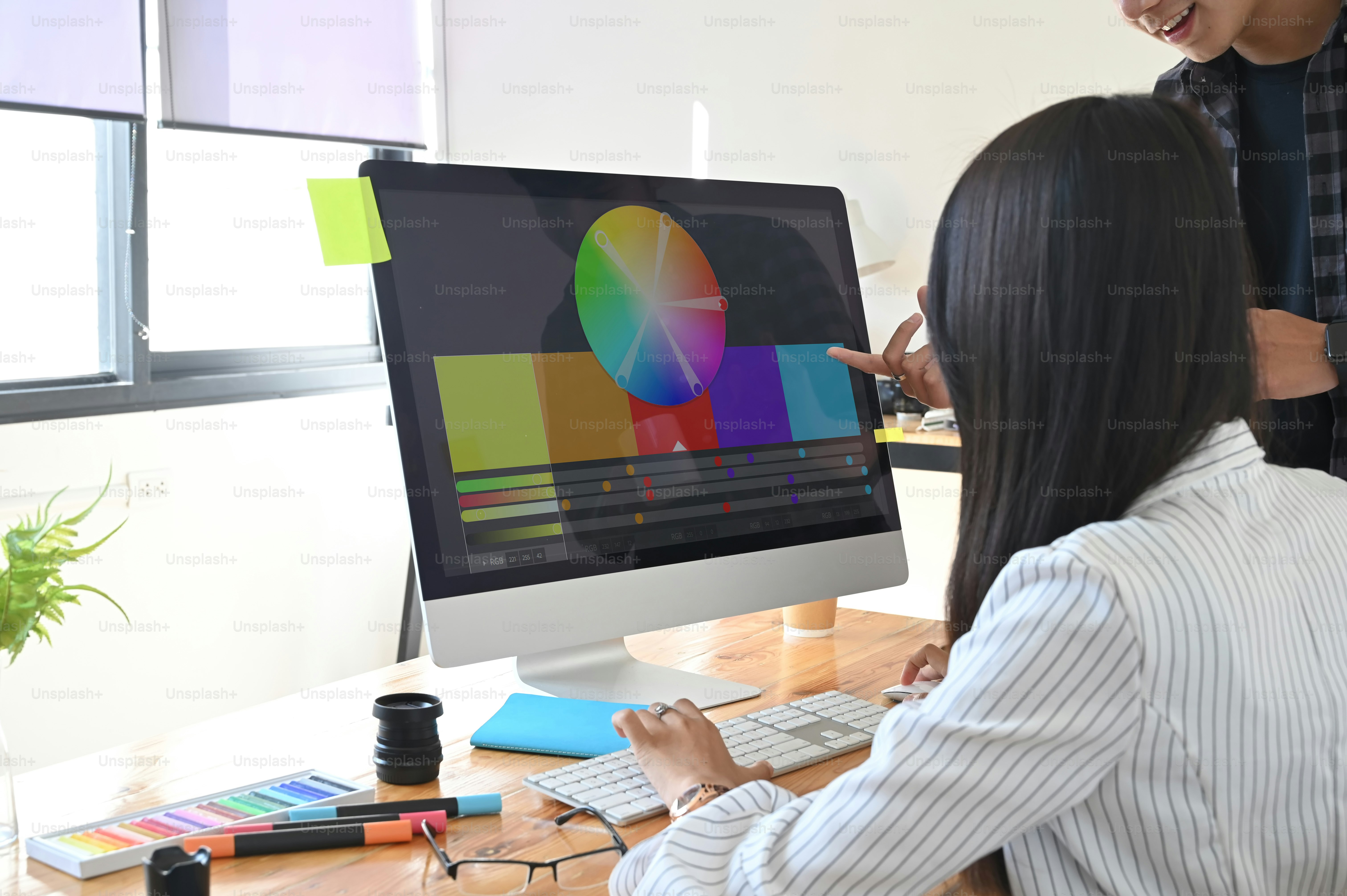 Cropped shot graphic designer working they selecting colour on computer.