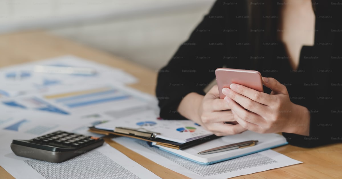 Cropped shot of young professional accountant summarising current ...
