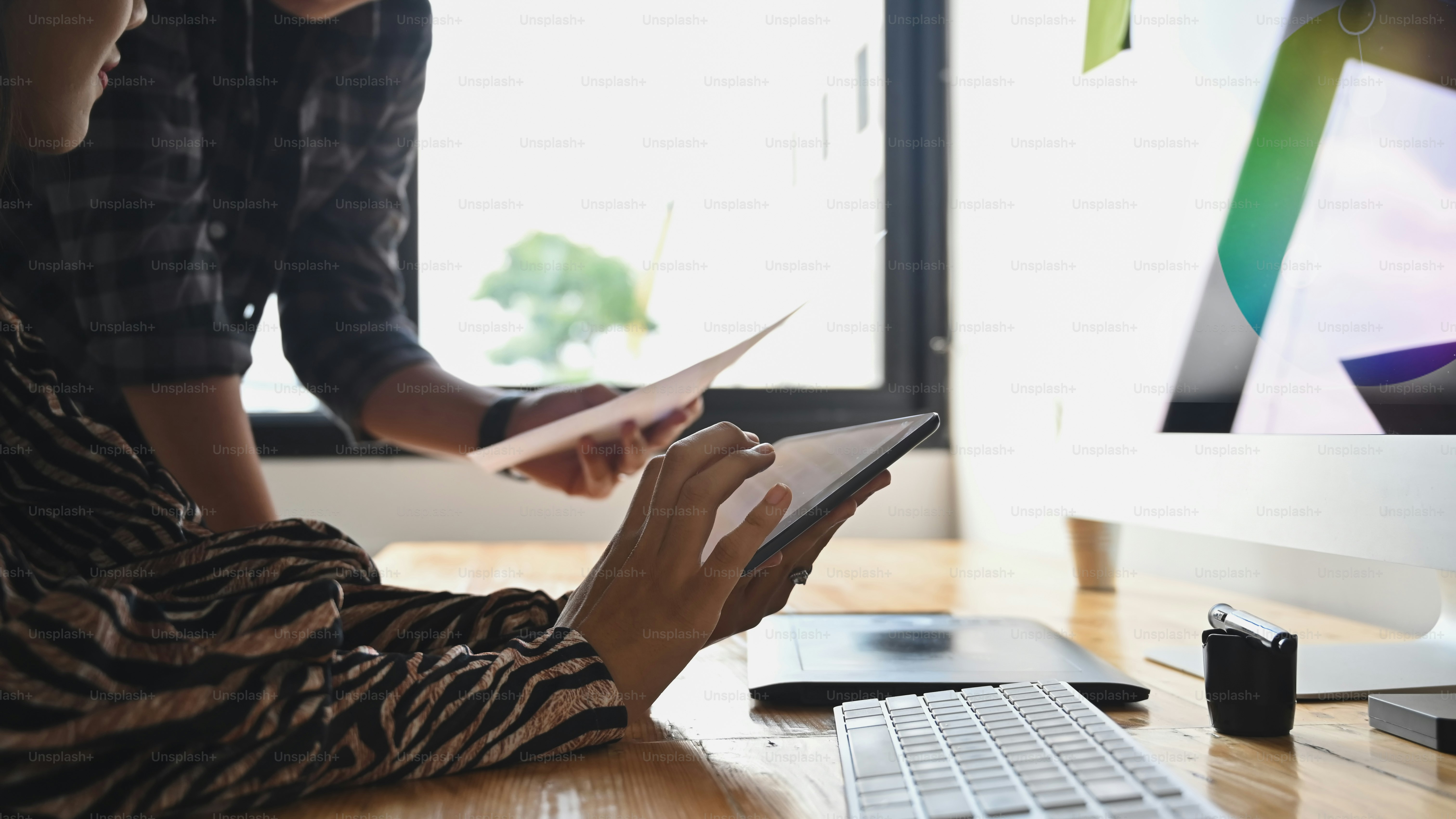 Closeup graphic designer working with tablet and computer.