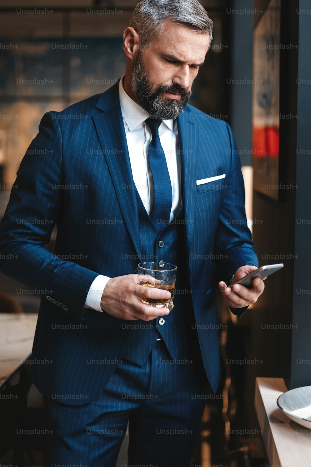 Formally dressed male executive manager in trendy clothes using mobile phone, Caucasian businessman sending text messages via smartphone connected to 4G internet for online chatting