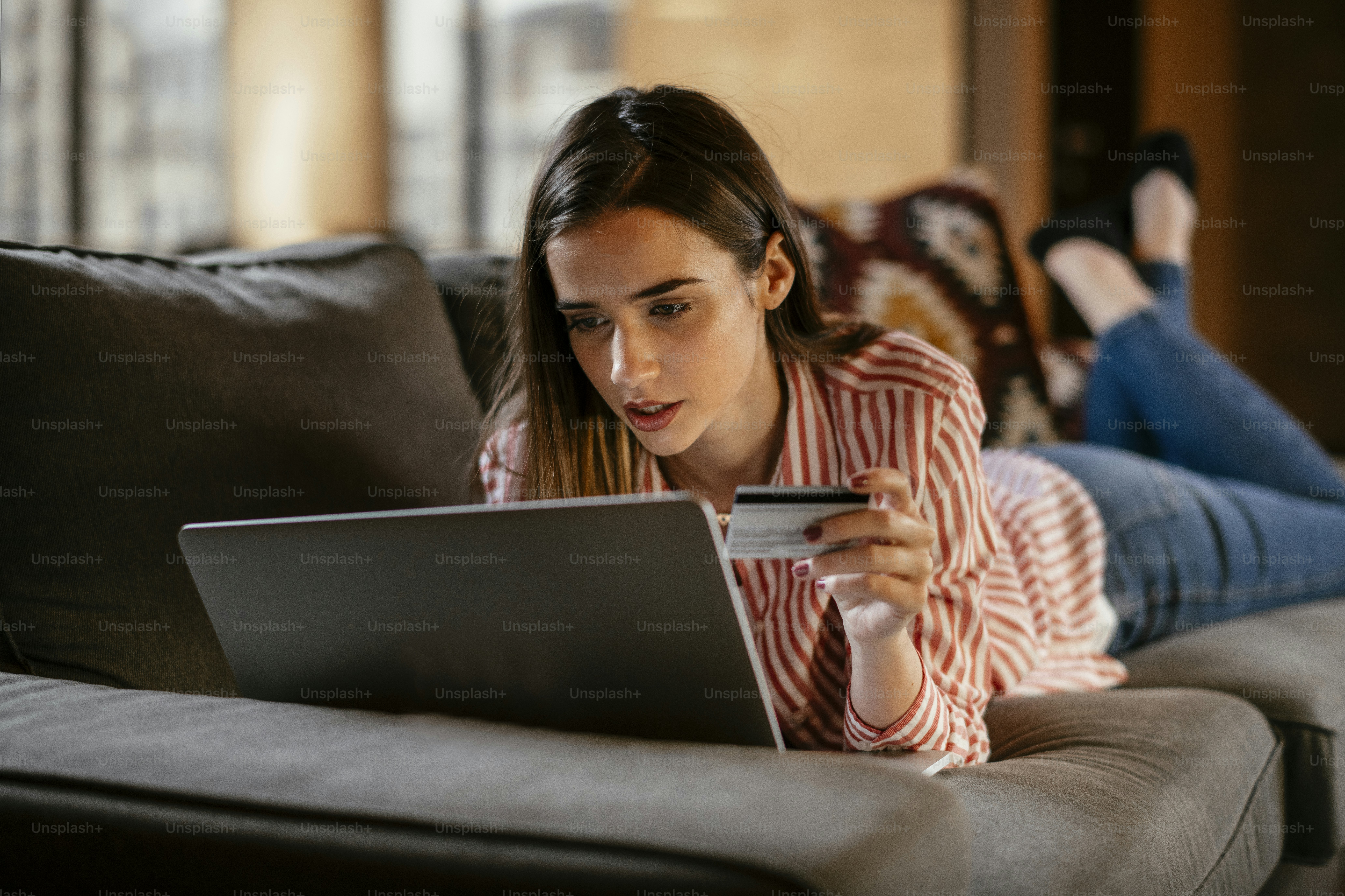 User reviewing VPN coupon codes online on a laptop while comparing subscription offers