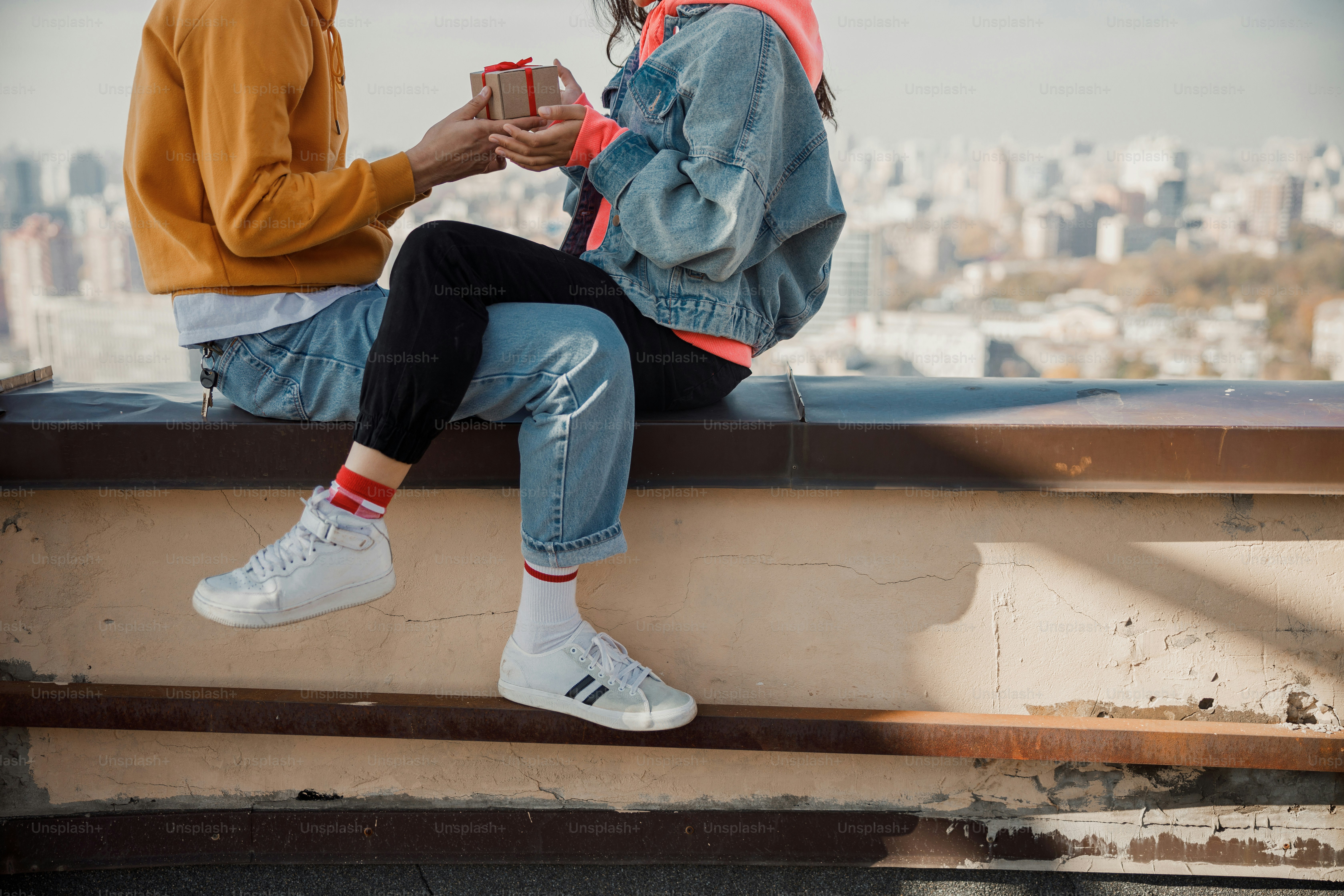 Cropped photo of couple with gift in their hands stock photo