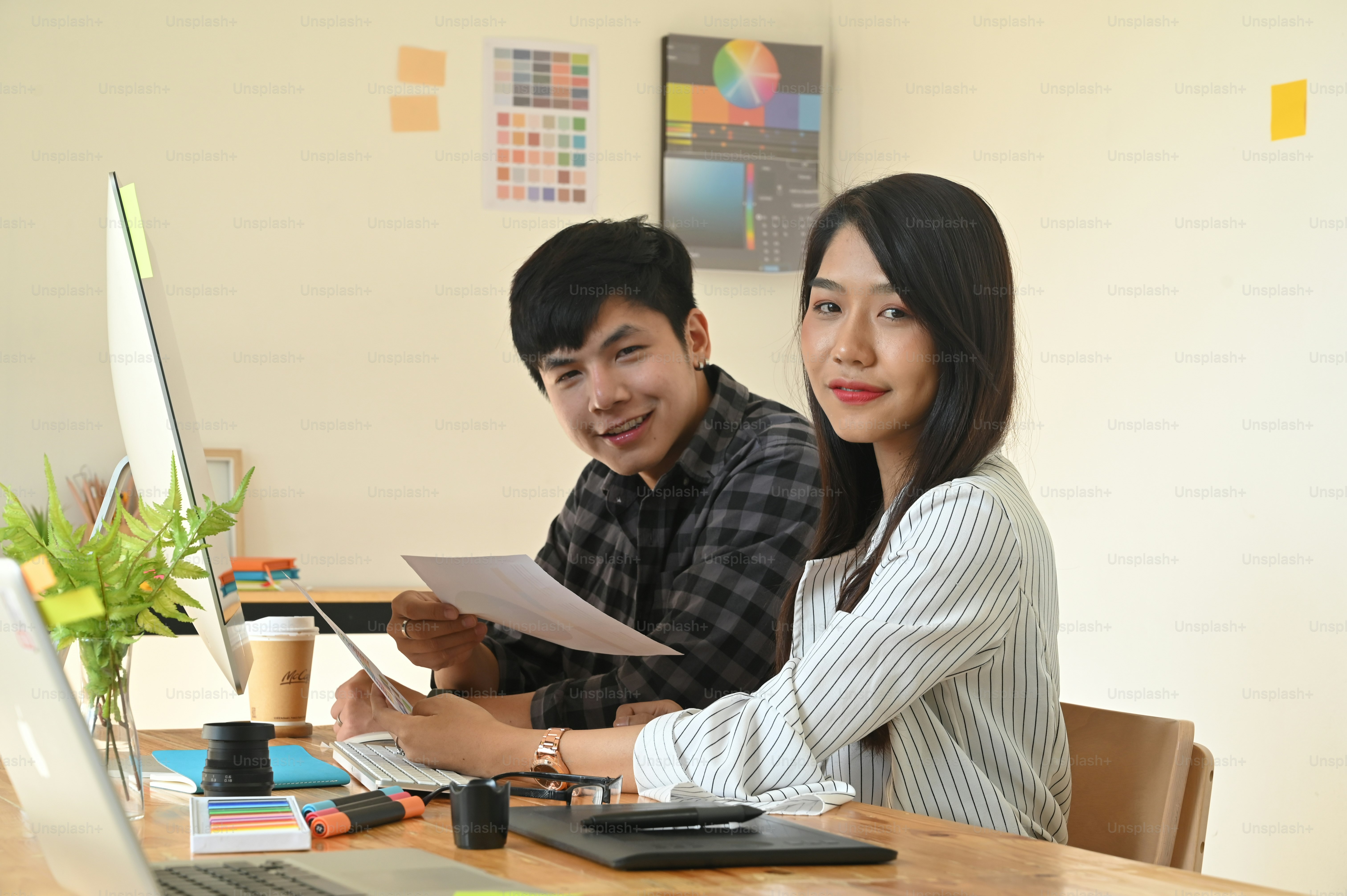 Portrait shot graphic designer they looking at camera.