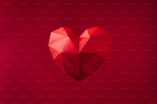 Valentines day background concept. Paper geometric volume heart on red background with blank space for text.