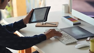Businessman using tablet and computer on the work desk.