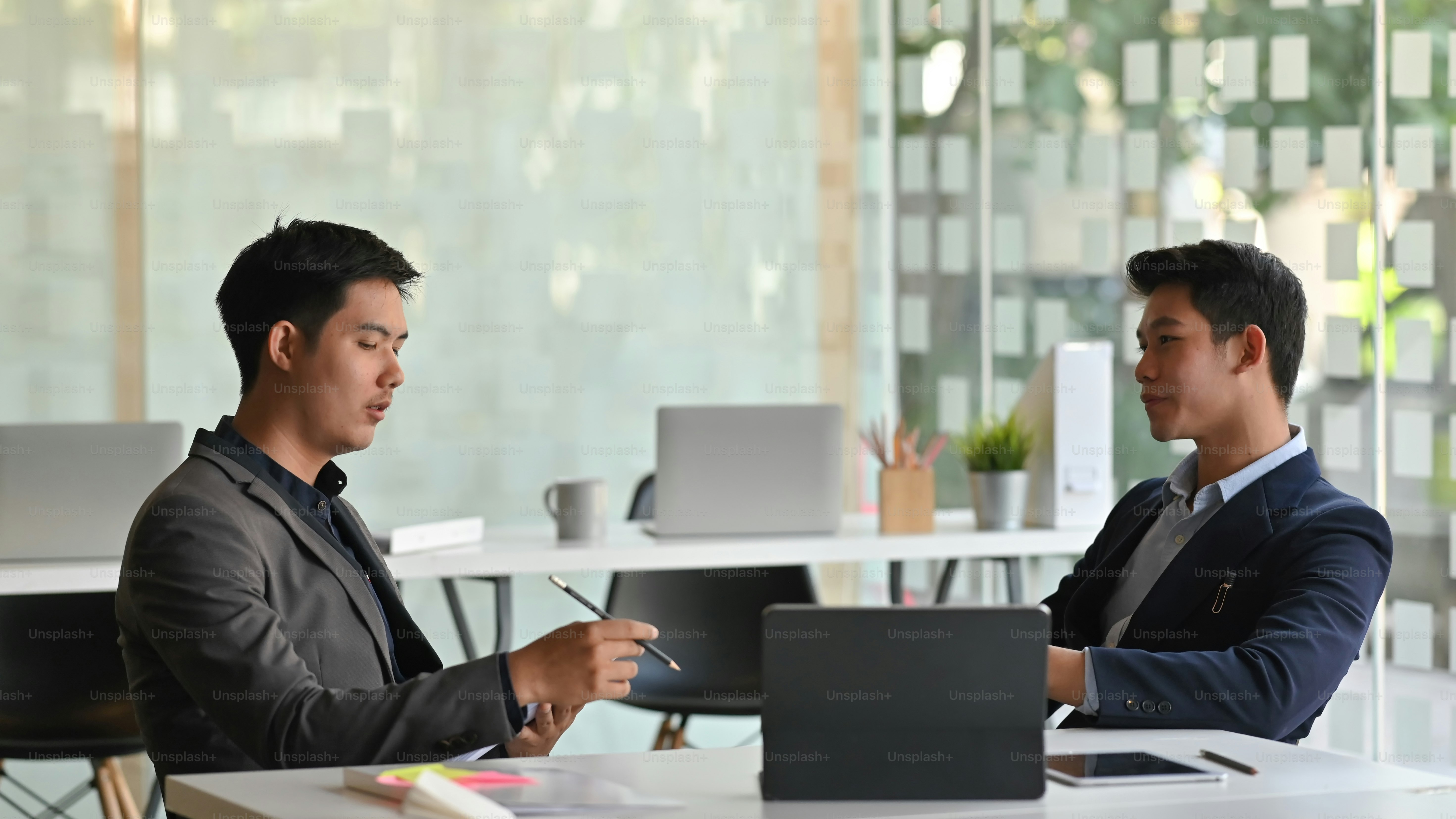 Photo of board of directors discussing about them business by using ...