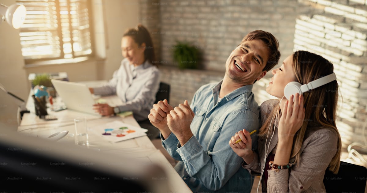 Young Cheerful Entrepreneurs Having Fun While Working Together In The young-cheerful-entrepreneurs-having-fun-while-working-together-in-the