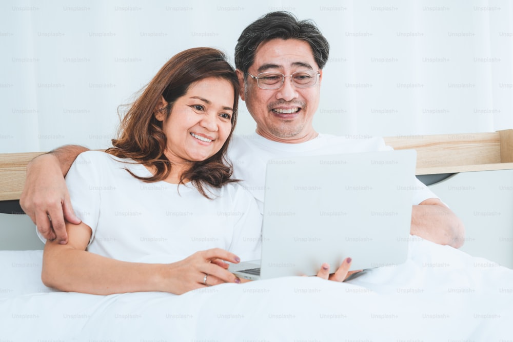 家で楽しい時間を過ごしている幸せなアジアの先輩夫婦。老人の退職と健康な市民の高齢者のコンセプト。