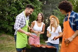 Group of young friends having barbecue party, outdoors