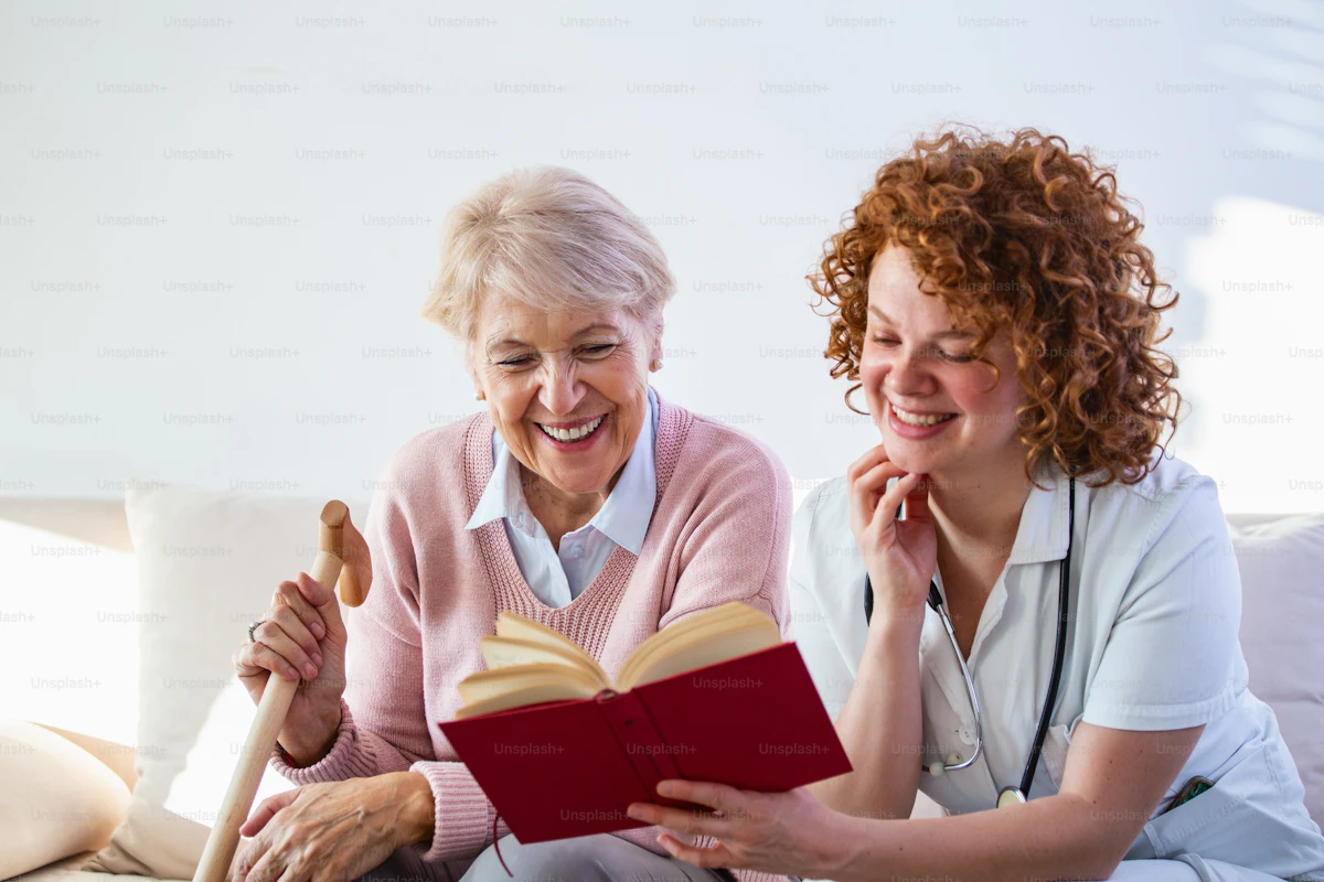 Caregiver spending time reading with an older client