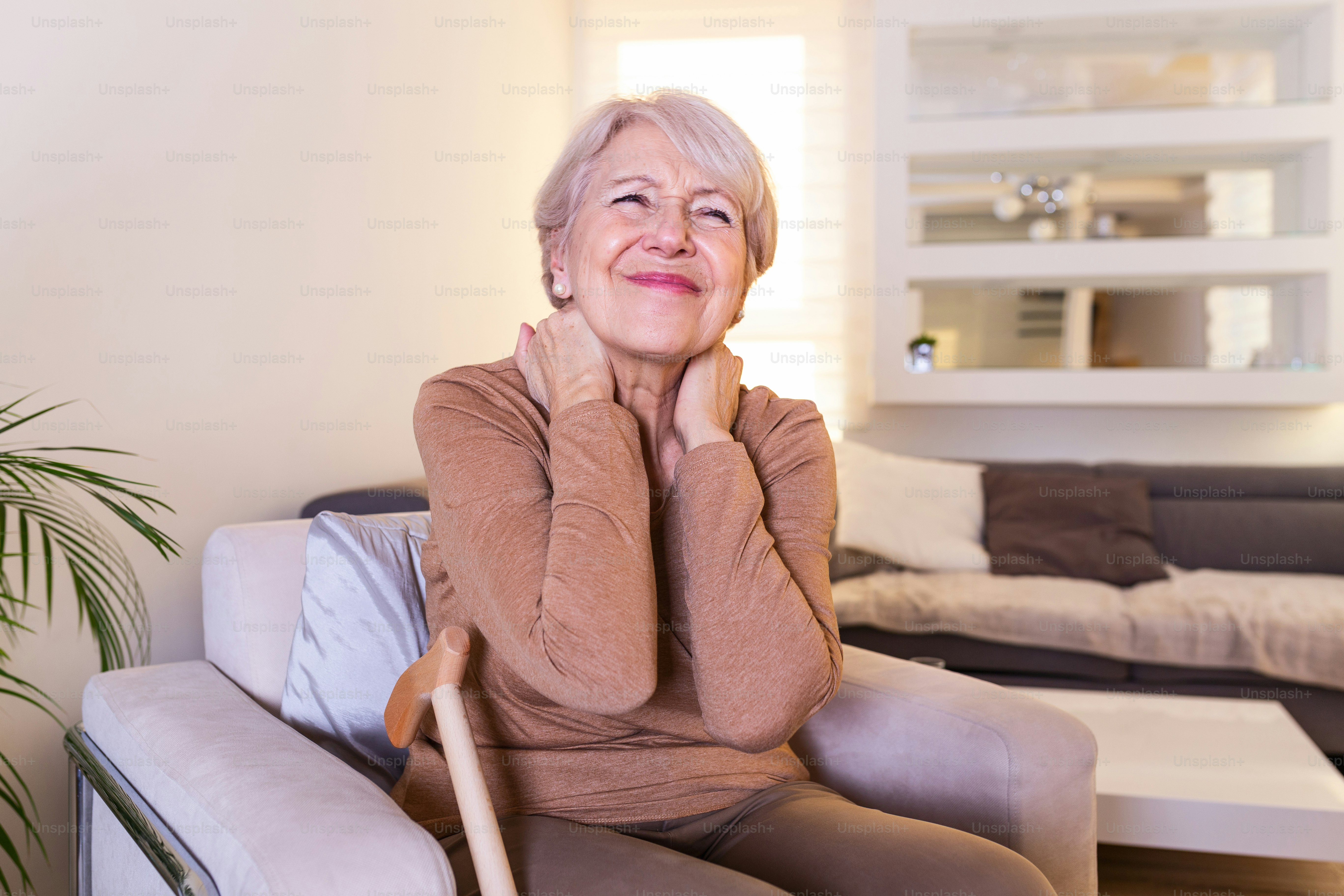 Senior woman feeling exhausted and suffering from neck pain, Health concept. Sad senior lady with neckache. Senior woman with chronic pain syndrome fibromyalgia suffering from acute neckaches.