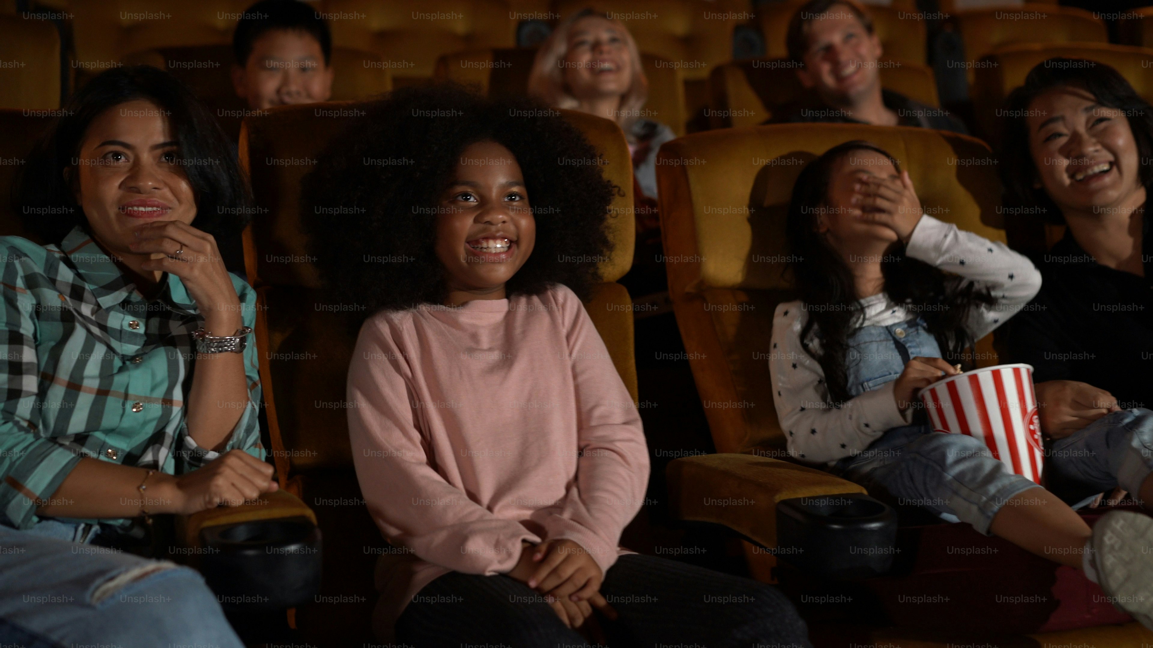 People audience watching movie in the movie theater cinema. Group recreation activity and entertainment concept.