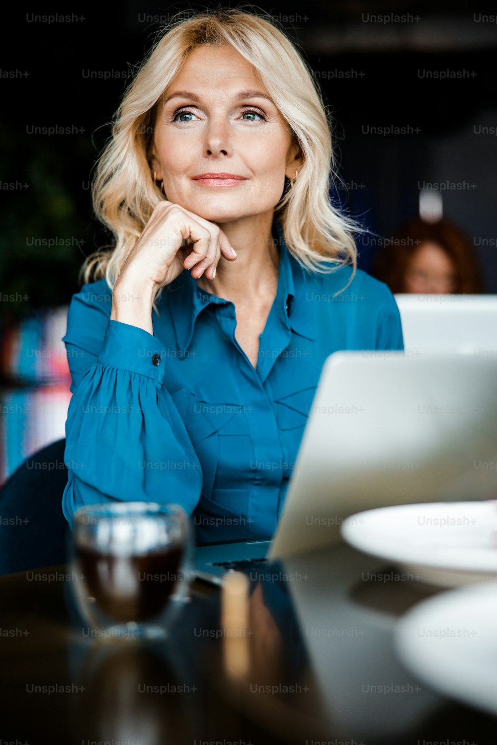 Charming elegant woman using modern laptop in cafe stock photo