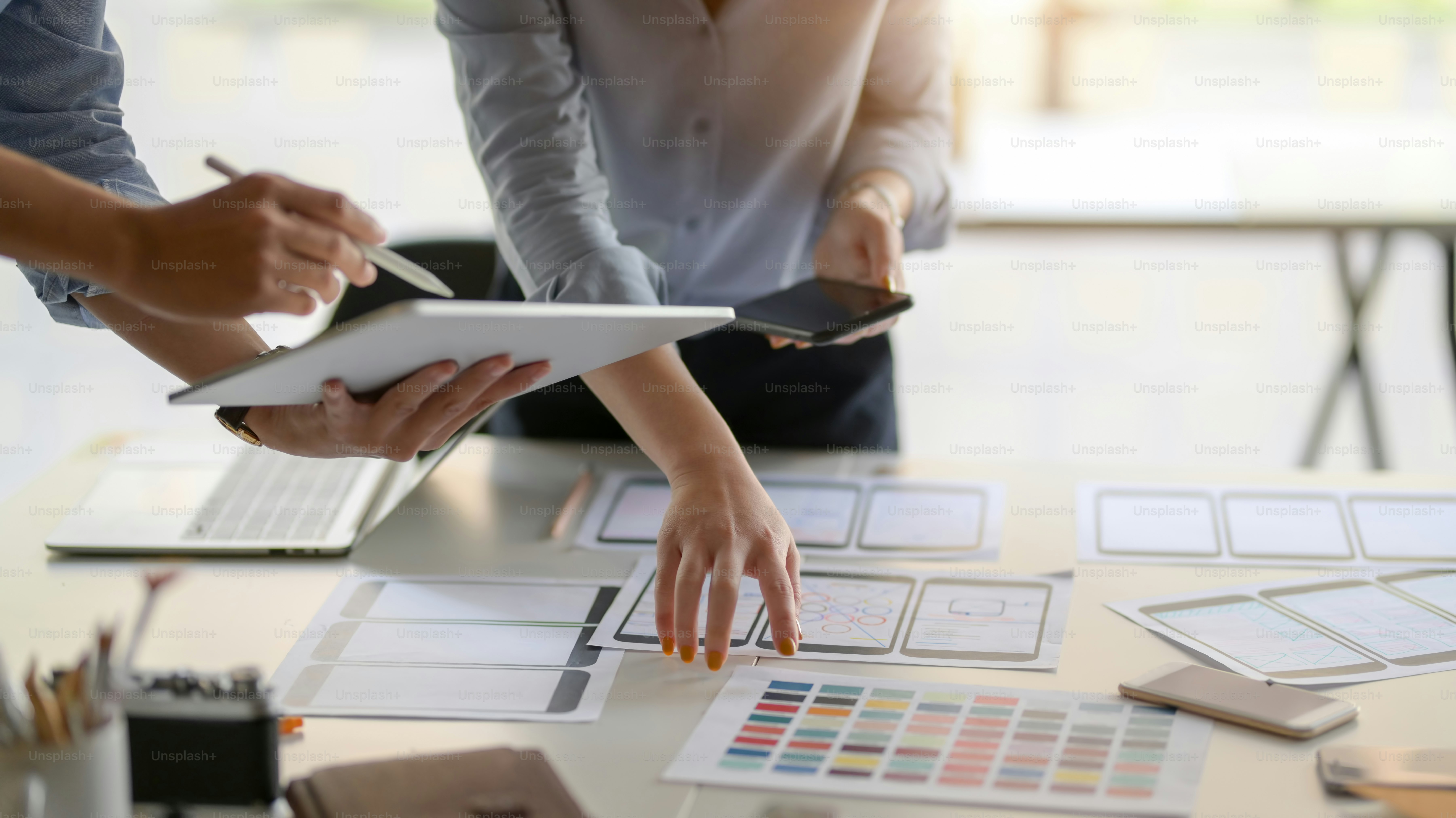 Close-up view of young UI designer team planing their smartphone template together