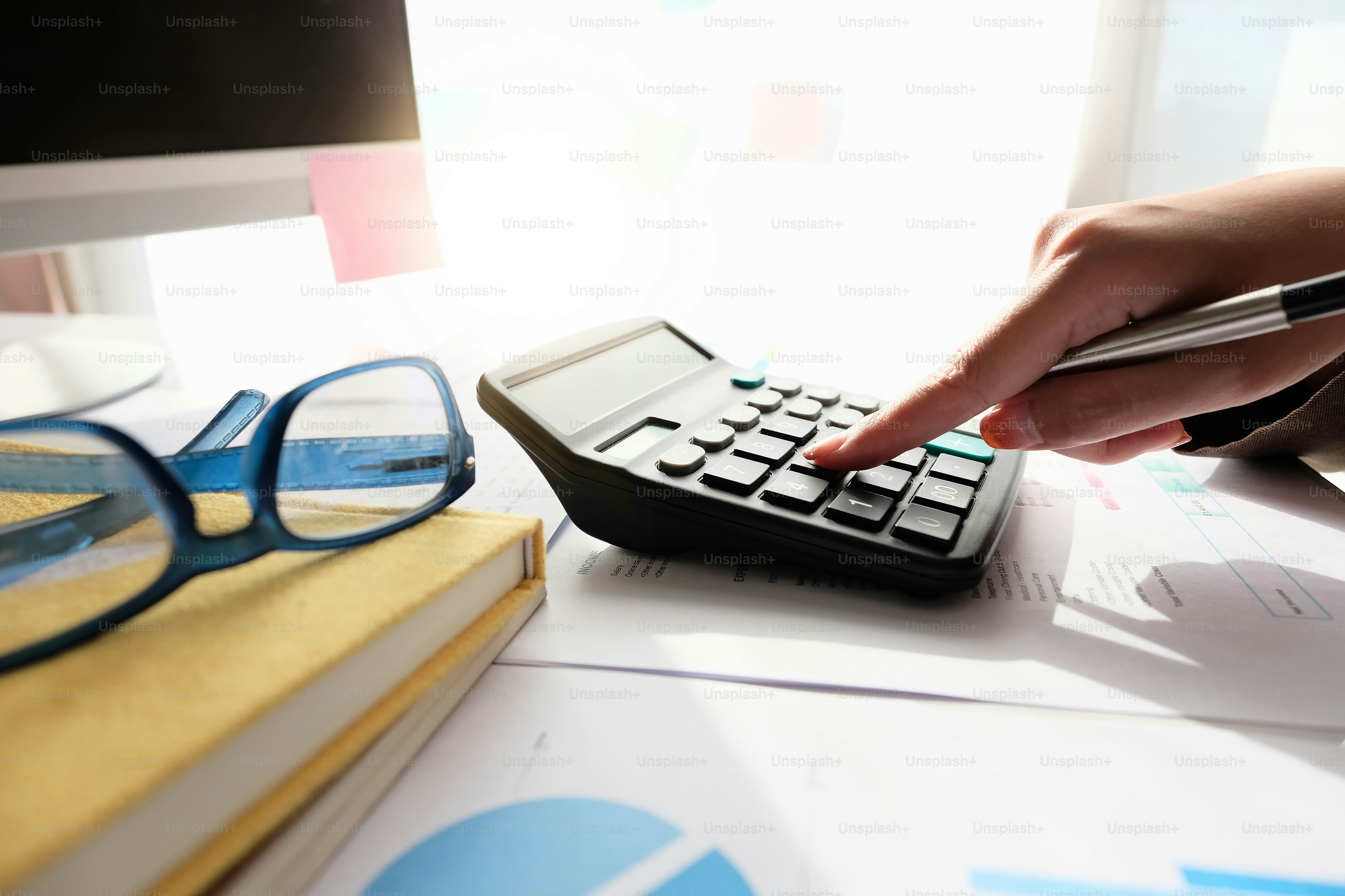 Close up Accountant using calculator for calculating financial expense at home office