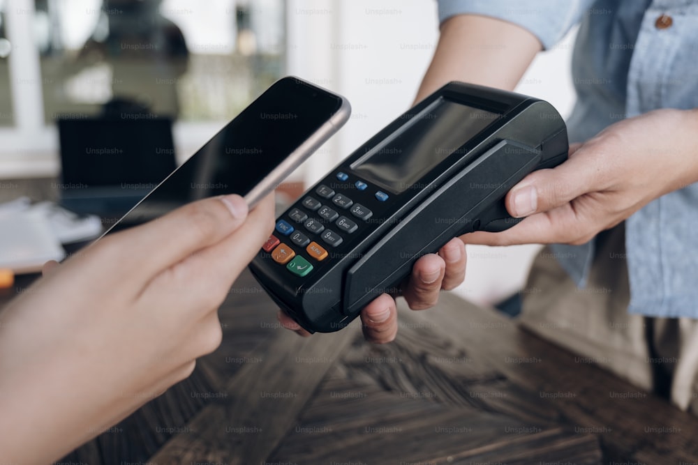Paying with mobile phone. NFC payment technology.
