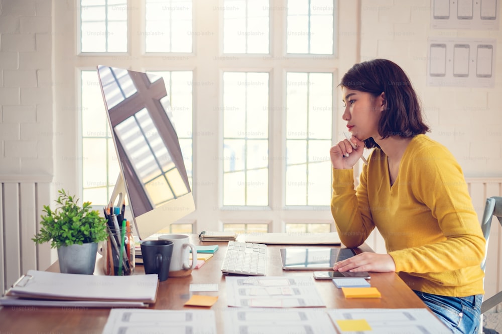 Designer woman drawing a website outline and website ux app development on mobile phone.