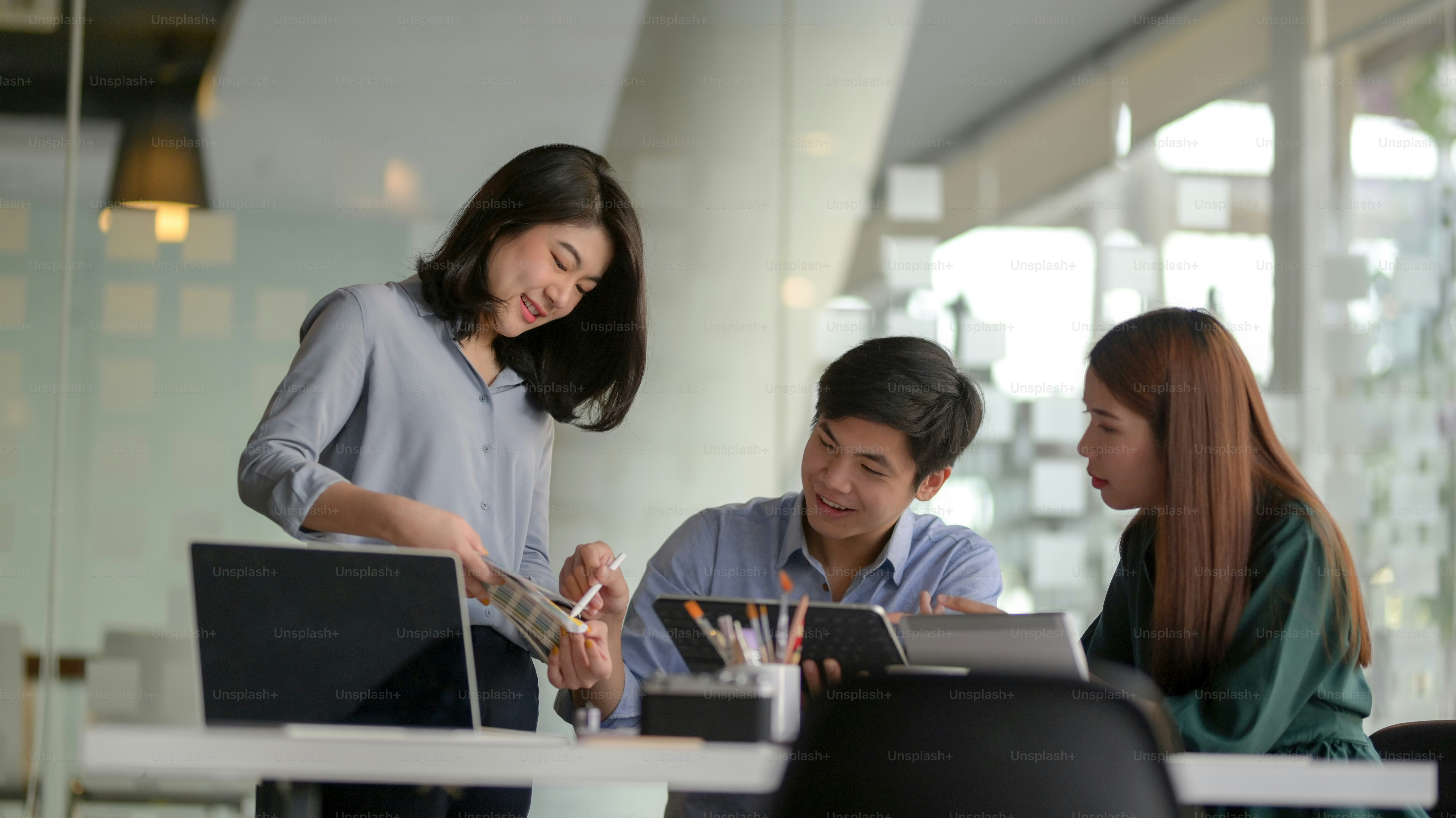 Young professional UI graphic designer group working on their project together in modern office room