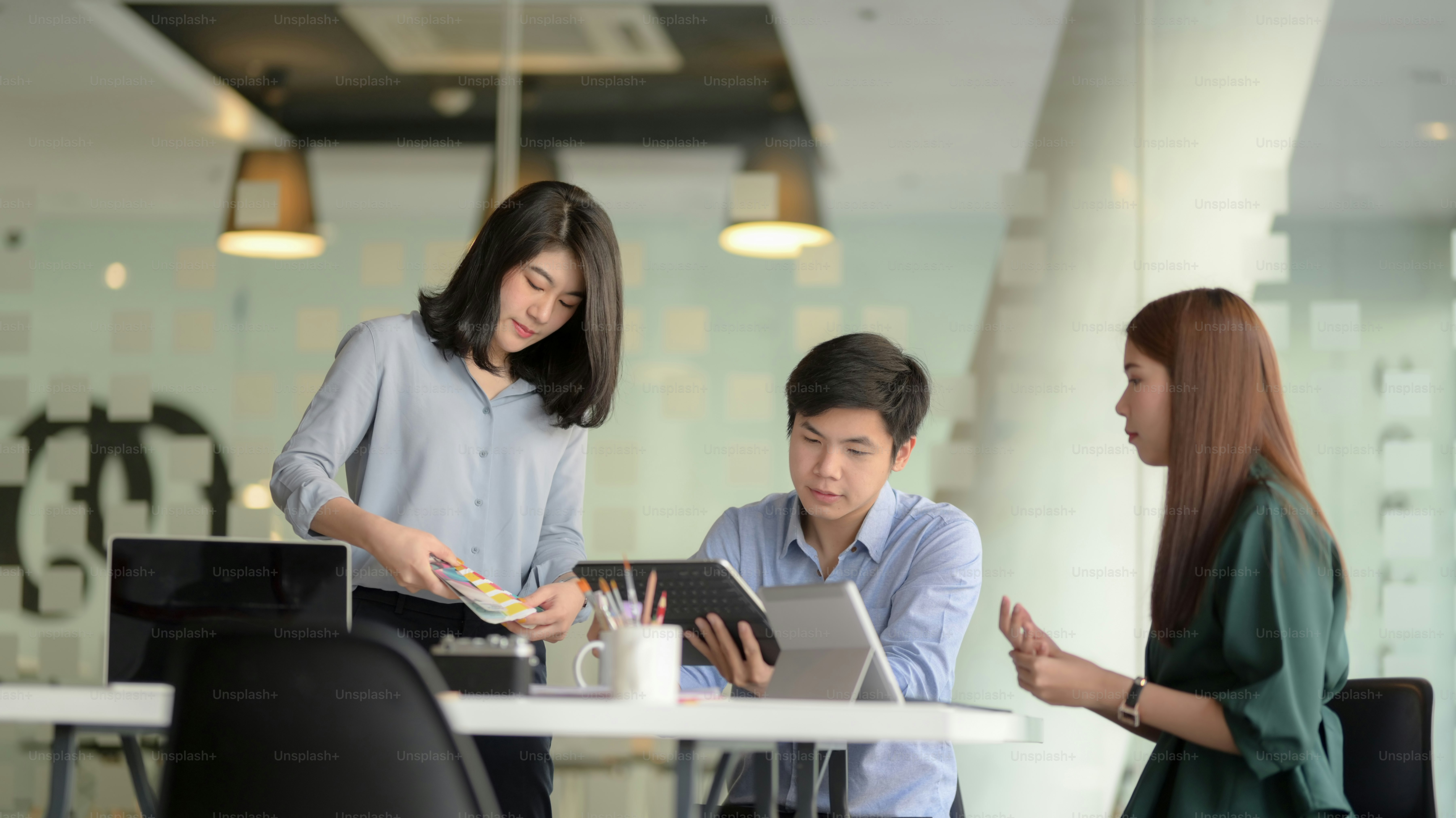 Young professional UI graphic designer group working on their project together in modern office room