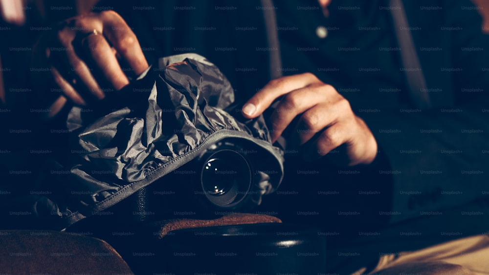 A man is secretly filming a video while watching a movie at the cinema