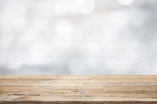 Empty wooden table for present product on white gray blur background with bokeh image. For montage product display.