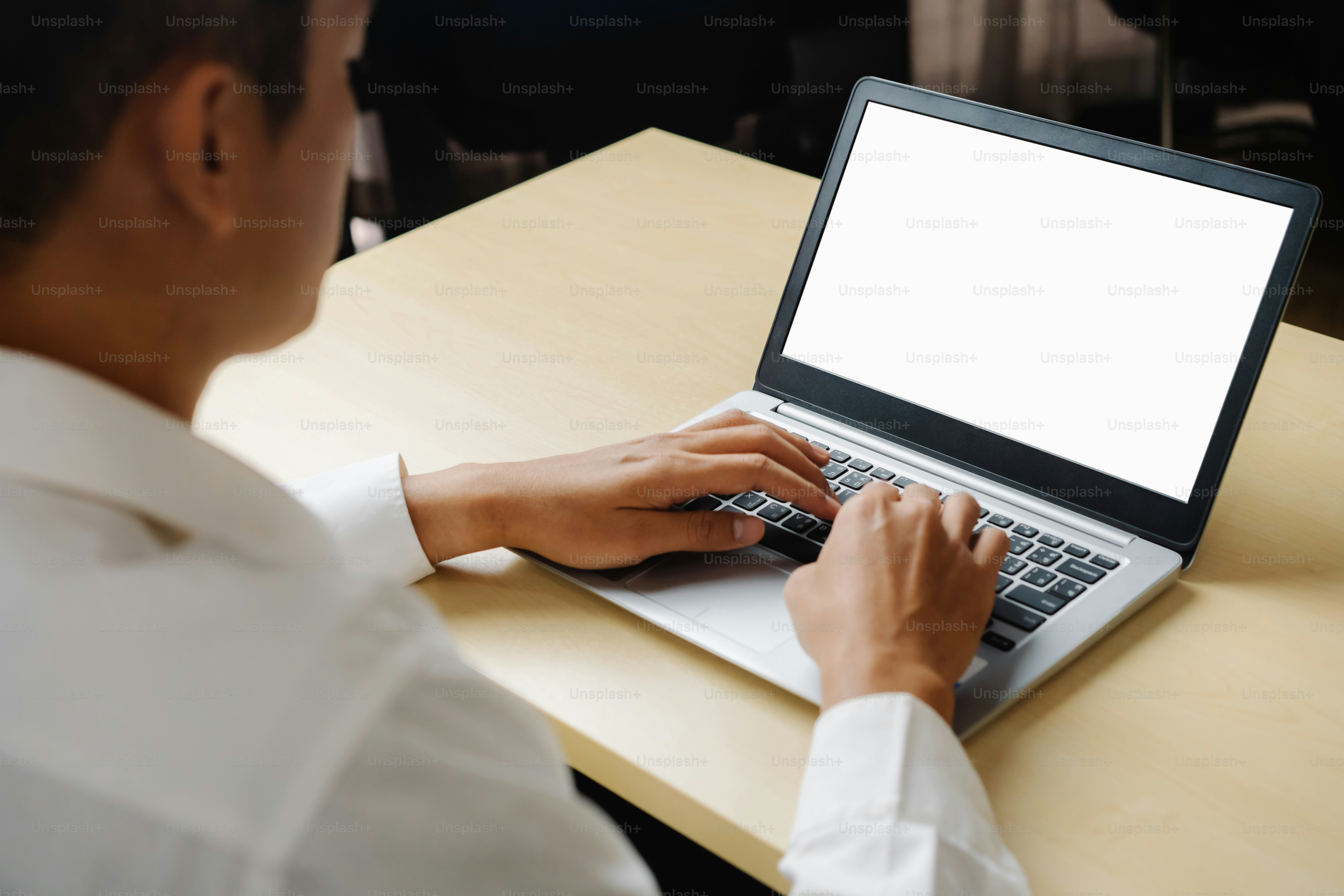 Business person or office worker using laptop computer while sitting at ...
