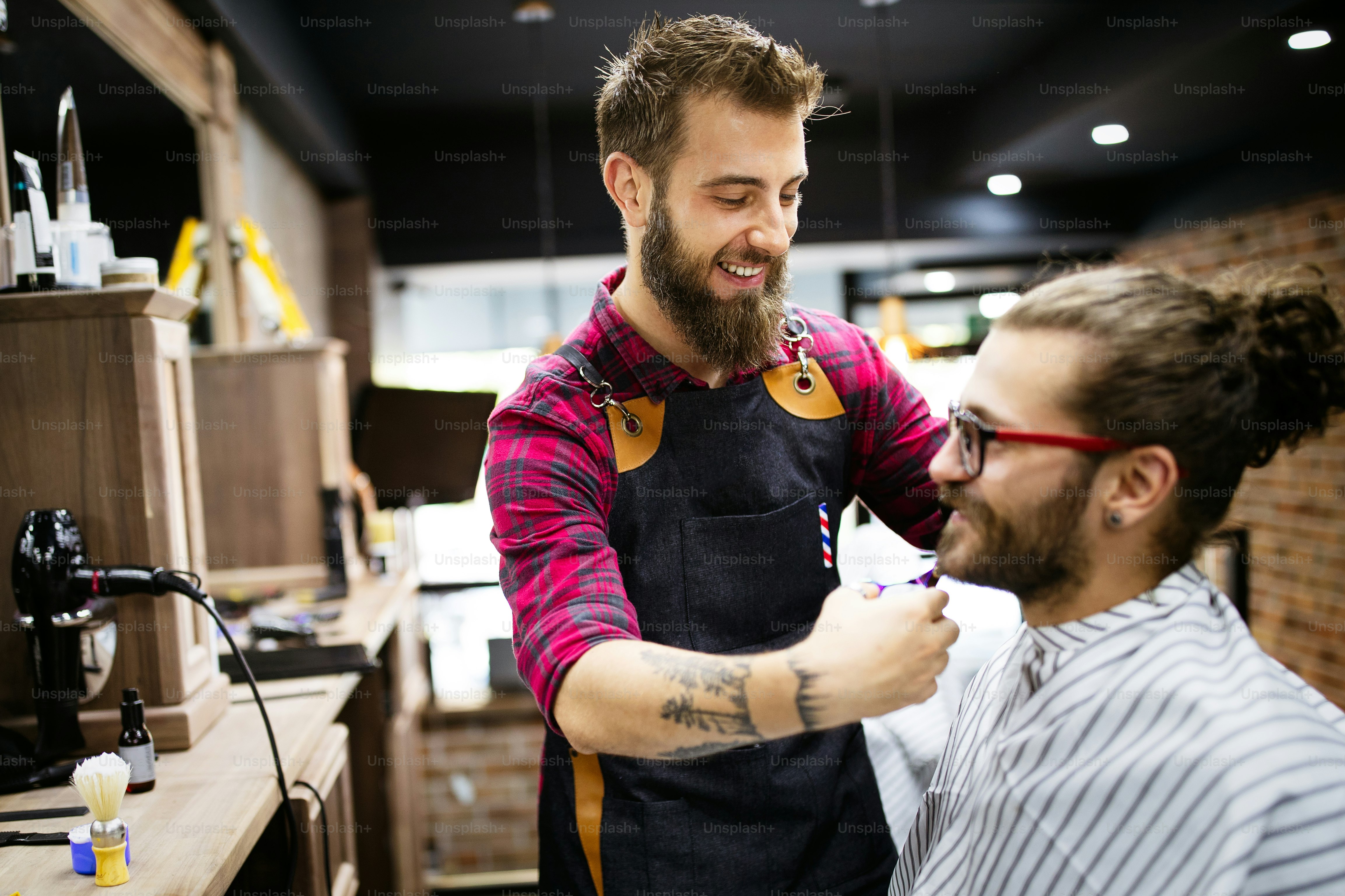 Man client during beard and moustache grooming in barber shop